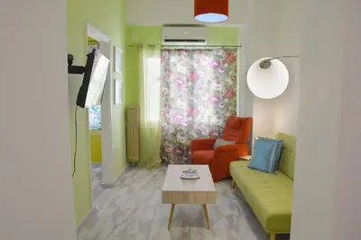 a living room with a couch and a table at Athens historical center Love suite 2 in Athens