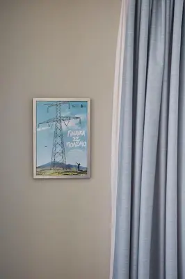 a picture hanging on a wall next to a curtain at Spacious Suite w. huge balcony + Acropolis view in Athens