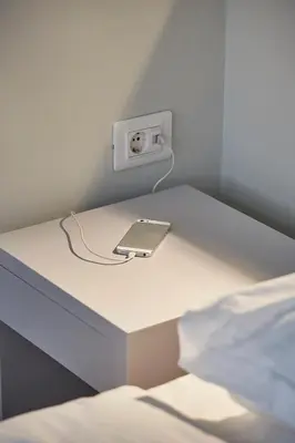 a room with a table with a phone plugged into an outlet at Spacious Suite w. huge balcony + Acropolis view in Athens
