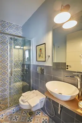 a bathroom with a toilet and a sink and a shower at Spacious Suite w. huge balcony + Acropolis view in Athens