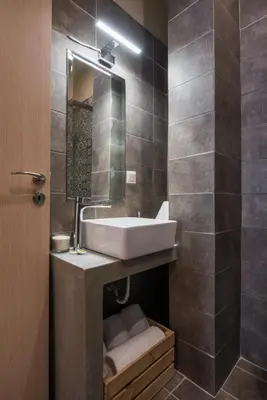a bathroom with a sink and a mirror at Stone house near Acropolis - Living Stone Diamond in Athens