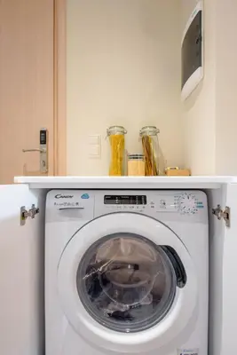 a washing machine with a shelf on top of it at Stone house near Acropolis - Living Stone Diamond in Athens