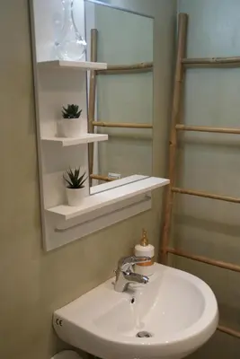a bathroom with a sink and a mirror at The Victoria Square Apartments in Athens