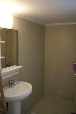 a bathroom with a sink and a mirror at The Victoria Square Apartments in Athens