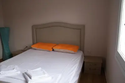 a bed with two orange pillows on top of it at The Victoria Square Apartments in Athens