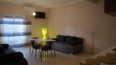 a living room with a couch and a table and chairs at The Victoria Square Apartments in Athens