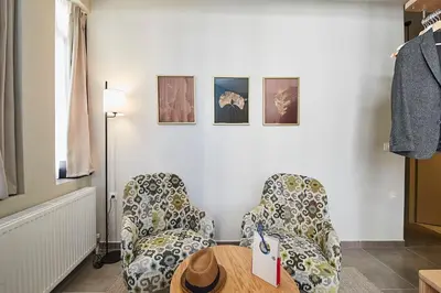 a room with two chairs and a wooden table at Be based near Acropolis, in an exquisite studio! in Athens