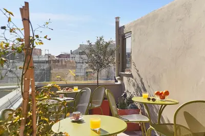 a balcony with tables and chairs and a window at Be based near Acropolis, in an exquisite studio! in Athens
