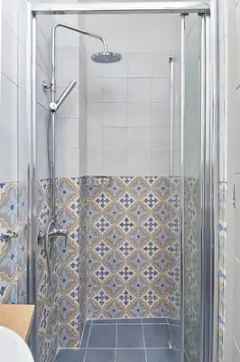 a shower with a glass door in a bathroom at Enjoy Athens from a funky studio near Acropolis! in Athens