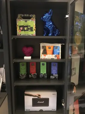 a book shelf with a box and other items at Bespoke House Athens in Athens