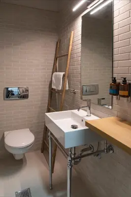 a bathroom with a sink and a toilet and a mirror at Bespoke House Athens in Athens