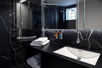 a bathroom with a sink and a mirror at Bespoke House Athens in Athens