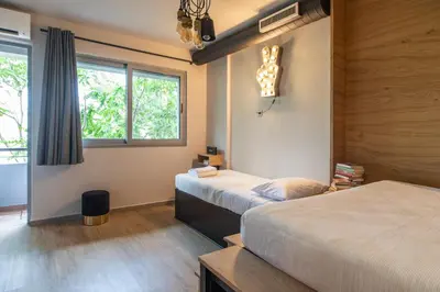 a bedroom with two beds and a window at Bespoke House Athens in Athens