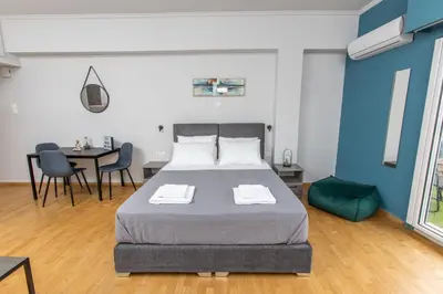 a bedroom with a bed and a table and chairs at Raise comfy studios in the heart of Athens in Athens