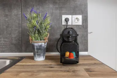 a drink cooler sitting on a kitchen counter next to a sink at Raise comfy studios in the heart of Athens in Athens
