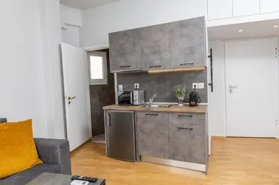 a kitchen with a sink and a microwave at Raise comfy studios in the heart of Athens in Athens