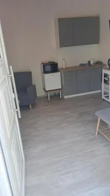 a room with a kitchen and a living room at Carpe Diem near the Athens airport in Markopoulo