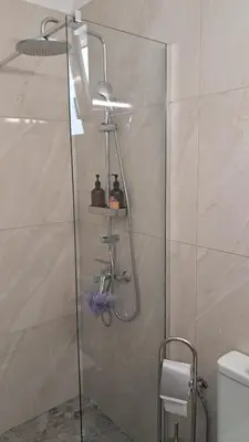 a shower with a glass door in a bathroom at Carpe Diem near the Athens airport in Markopoulo