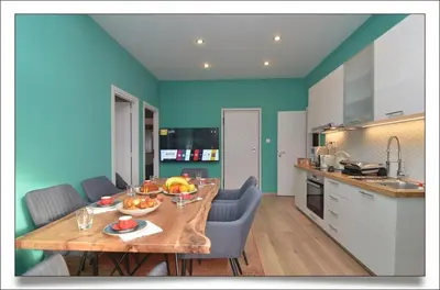 a kitchen with a wooden table with fruit on it at Sophia's Penthouse Apartment With Jacuzzi and Acropolis View From Big Terrace in Athens