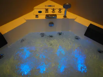 a bath tub with blue lights in a bathroom at Sophia's Penthouse Apartment With Jacuzzi and Acropolis View From Big Terrace in Athens