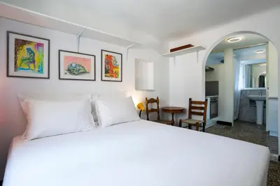 a bedroom with a white bed and a dining room at Enticing, Cosy, Rooftop Studio Athens Centre! EP9T in Athens