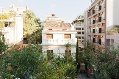a white house in the middle of some buildings at Enticing, Cosy, Rooftop Studio Athens Centre! EP9T in Athens