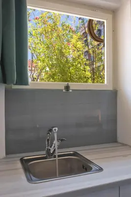 a sink in a kitchen with a window at Enticing, Cosy, Rooftop Studio Athens Centre! EP9T in Athens