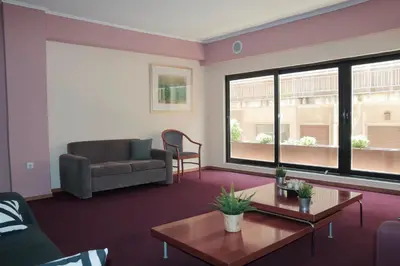 a living room with a couch and a table at Hotel Victory in Athens