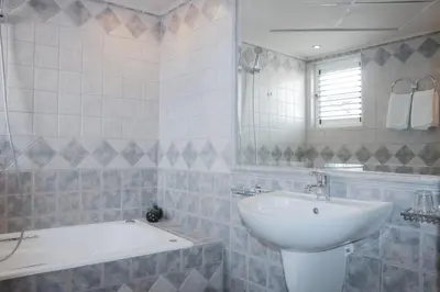 a bathroom with a sink and a bath tub at Hotel Victory in Athens