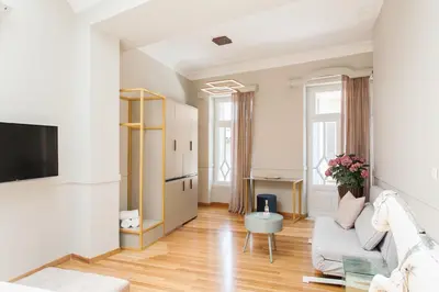 a living room with a couch and a tv at Step One | Luxury Suites right in the heart of Acropolis next to metro station in Athens