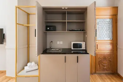 a small kitchen with a sink and a microwave at Step One | Luxury Suites right in the heart of Acropolis next to metro station in Athens