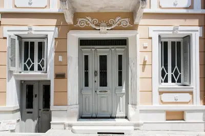 a building with a blue door and two windows at Step One | Luxury Suites right in the heart of Acropolis next to metro station in Athens