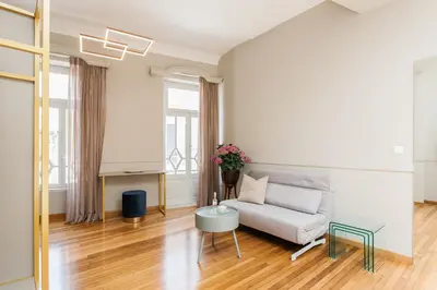 a living room with a couch and a table at Step One | Luxury Suites right in the heart of Acropolis next to metro station in Athens