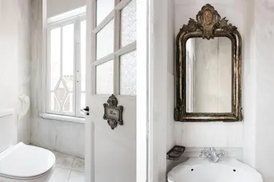 a bathroom with a toilet and a mirror on the wall at Step One | Luxury Suites right in the heart of Acropolis next to metro station in Athens