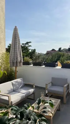a patio with two couches and a table at Step One | Luxury Suites right in the heart of Acropolis next to metro station in Athens