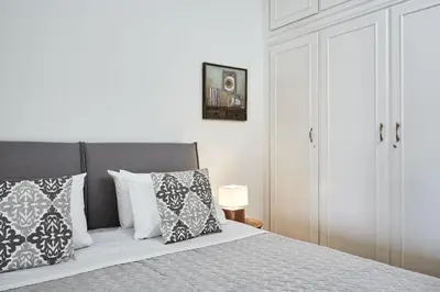 a bedroom with a bed with pillows on it at Chic One Bd Apartment with Hilton View in Athens