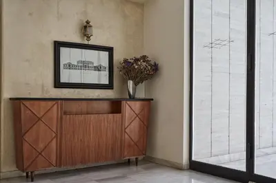 a cabinet in a room with a picture on the wall at Chic One Bd Apartment with Hilton View in Athens