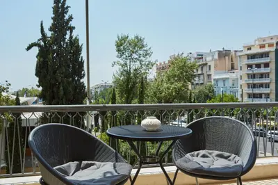 a table and two chairs on a balcony at Chic One Bd Apartment with Hilton View in Athens