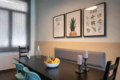 a dining room table with a bowl of fruit and candles at Athens Downtown Loft in Athens