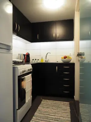 a kitchen with black cabinets and a bowl of fruit at Athens Downtown Loft in Athens