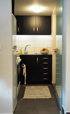 a kitchen with black and white cabinets and a bowl of fruit at Athens Downtown Loft in Athens