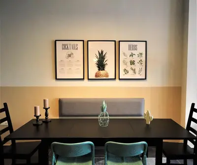 a dining room table with four pictures on the wall at Athens Downtown Loft in Athens