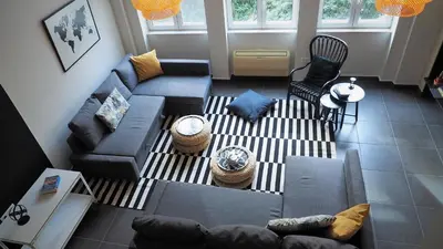 an overhead view of a living room with a couch and chairs at Athens Downtown Loft in Athens