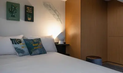 a bedroom with a bed with two pillows at Athens Downtown Loft in Athens