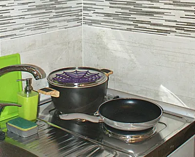 a pot and a pan on a stove in a kitchen at Sunny studio with Parthenon view balcony in Athens