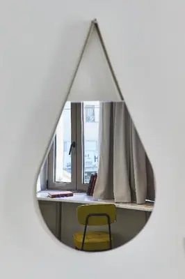 a mirror with a yellow chair in front of a desk at Explore Athens from an uber-central studio! in Athens