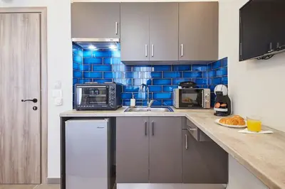 a kitchen with a sink and a microwave at Live in a funky & renovated studio near Acropolis in Athens
