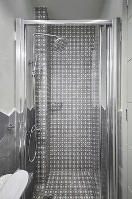 a shower with a glass door in a bathroom at Live in a funky & renovated studio near Acropolis in Athens