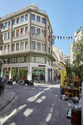 a large building with motorcycles parked in front of it at Live in a funky & renovated studio near Acropolis in Athens