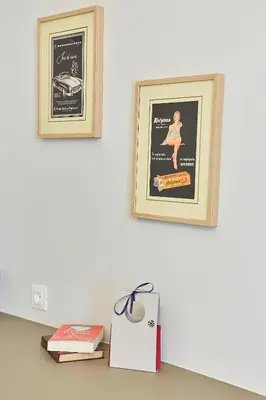 two framed posters on a wall with books on a table at Old Athens style 1bdr with Acropolis view rooftop! in Athens